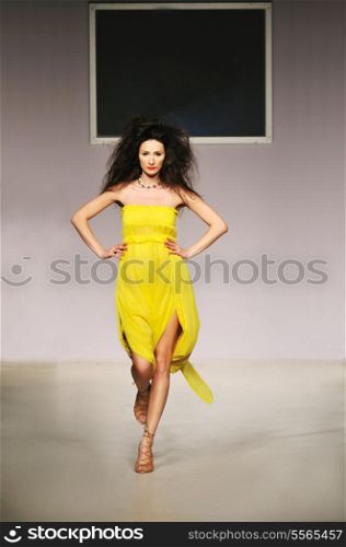 young beautiful model walking on fashion show piste
