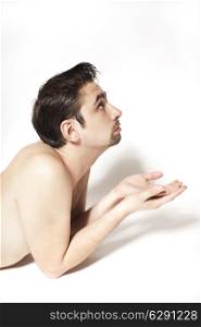 young beautiful naked guy with a stylish haircut on a white background