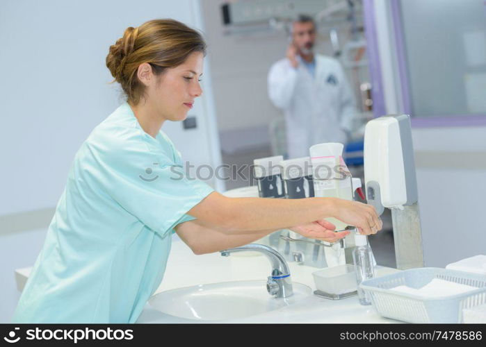 young beautiful nurse washes hands