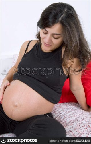 young beautiful pregnant woman in bed