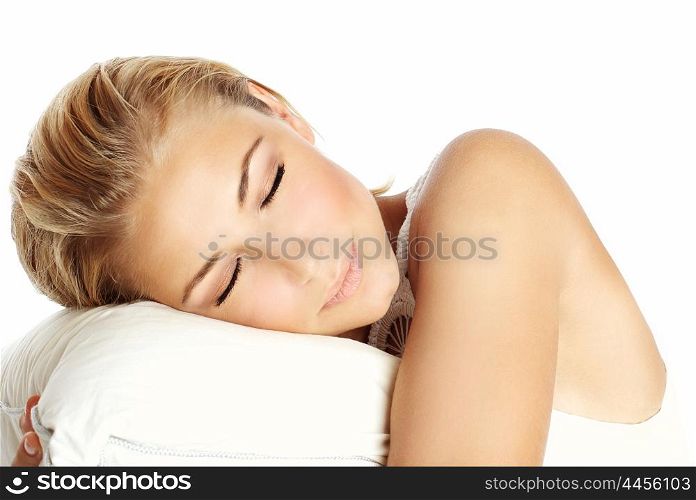 Young beautiful sleeping girl, lying on the pillow and dreaming, isolated on white background, health care concept