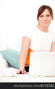 young beautiful smiling woman prints on the laptop - indoors