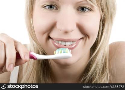 Young beautiful smiling woman with white teeth holding a tooth brush