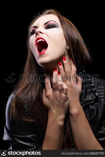 Young beautiful vampire woman on black