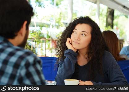 Young beautiful woman bored at a date in coffee shop.