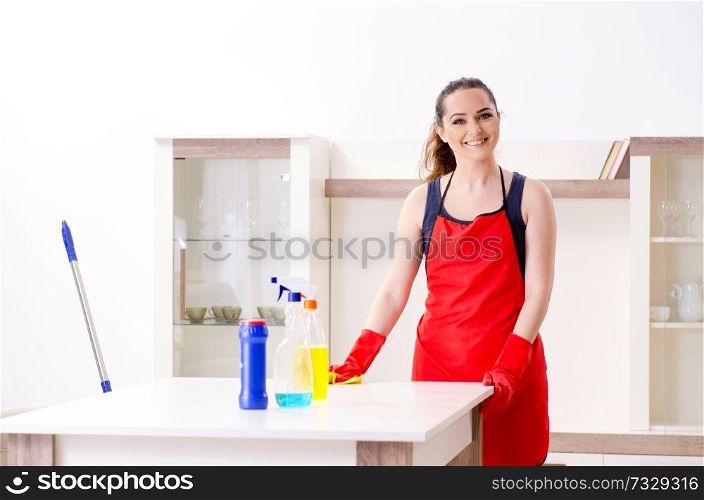 Young beautiful woman cleaning apartment 