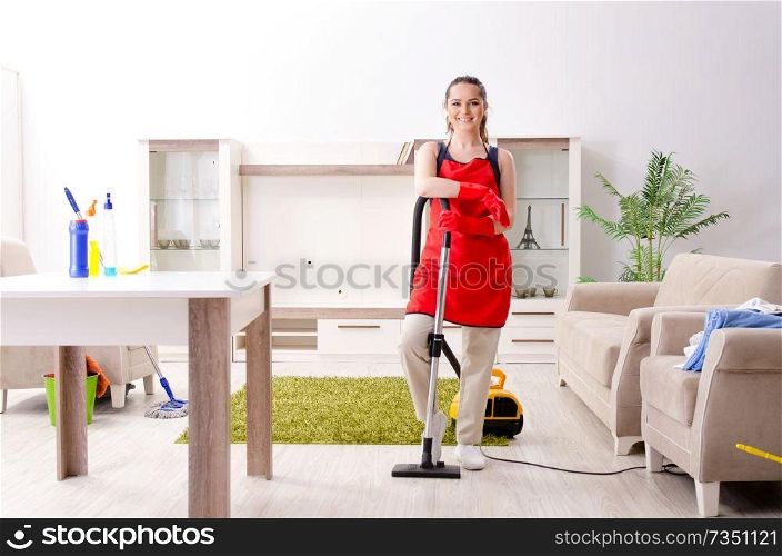 Young beautiful woman cleaning apartment 