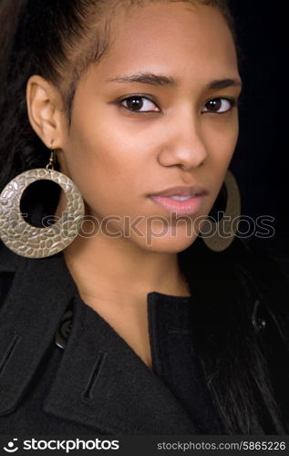 young beautiful woman close up portrait, on black background