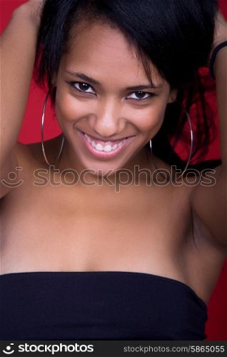 young beautiful woman closeup portrait, on a red background