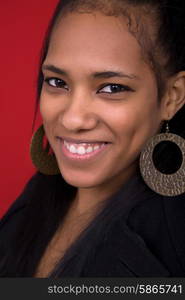 young beautiful woman closeup portrait, on a red background