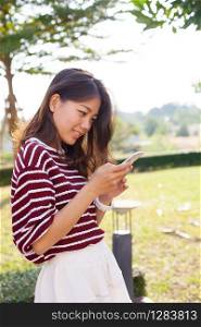young beautiful woman connecting by chat and reading message in smart phone use for modern people activities and lifestyle in digital life