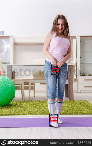 Young beautiful woman doing exercises at home 