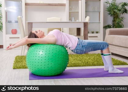 Young beautiful woman doing exercises at home 