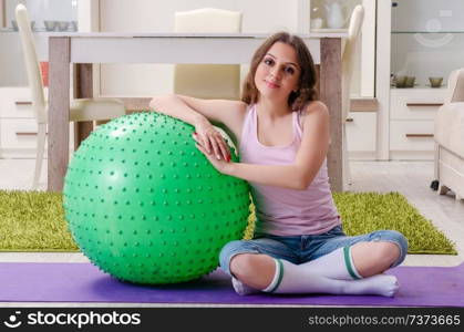 Young beautiful woman doing exercises at home 