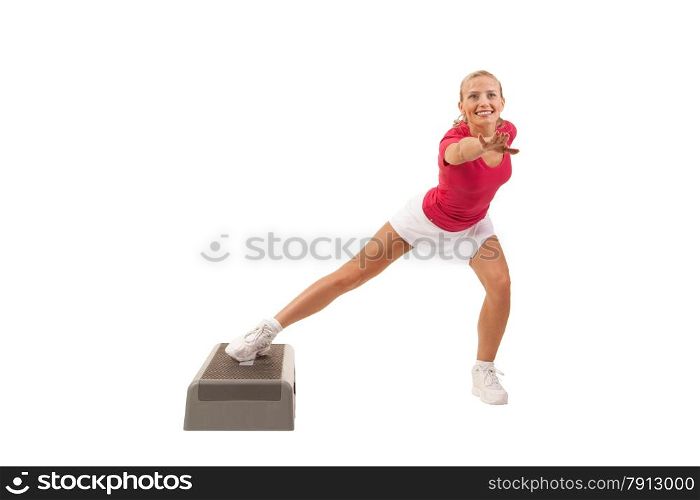 Young beautiful woman doing exercises on the stair stepper