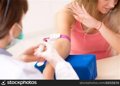 Young beautiful woman during blood test s&ling procedure  . Young beautiful woman during blood test s&ling procedure 