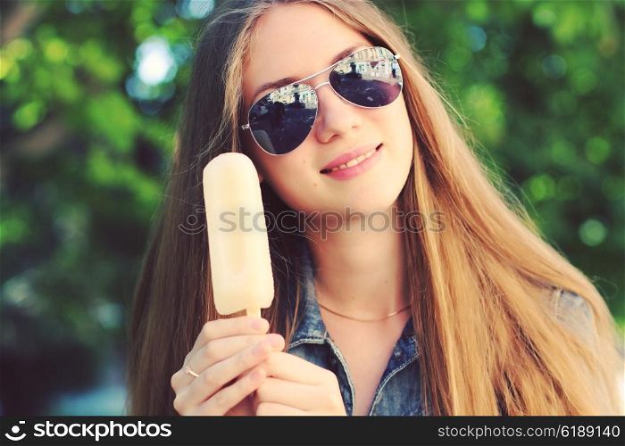 Young beautiful woman eating popsicle ice pop. Photo toned style Instagram filters