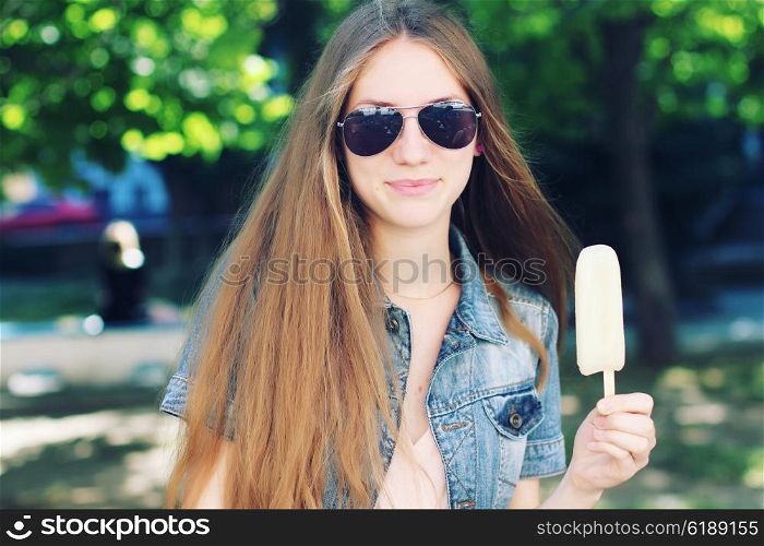 Young beautiful woman eating popsicle ice pop. Photo toned style Instagram filters