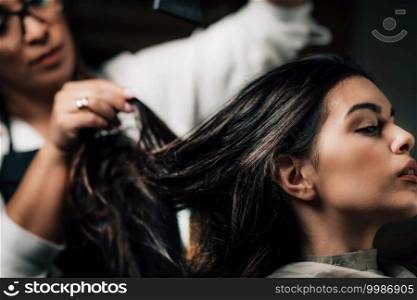 Young beautiful woman getting hair drying in beauty salon.. Hair Salon, Hairdresser Drying Hair