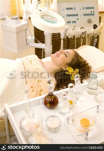 Young beautiful woman having beauty teatment in the beauty shop with the morden beauty equipment.