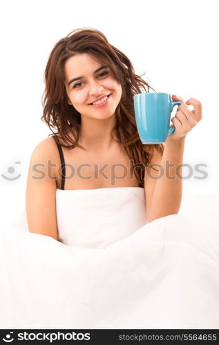 Young beautiful woman having breakfast in bed