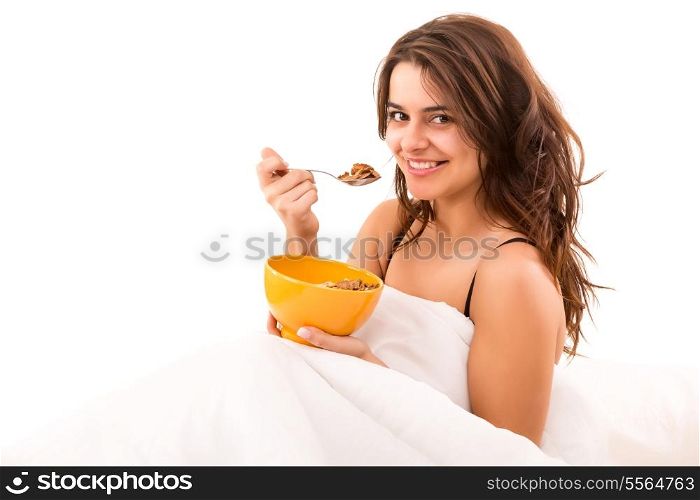 Young beautiful woman having breakfast in bed