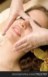Young beautiful woman having facial lymphatic massage