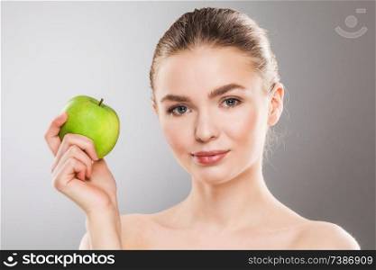 Young beautiful woman holding green apple. Woman with green apple