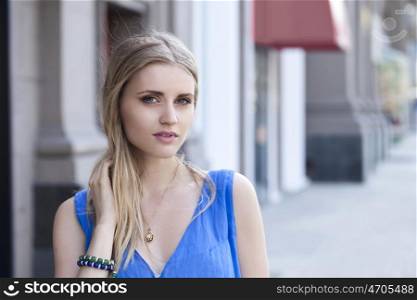 Young beautiful woman in a blue dress