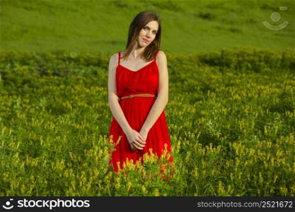 Young beautiful woman in a red dress smiling