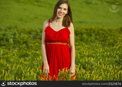 Young beautiful woman in a red dress smiling