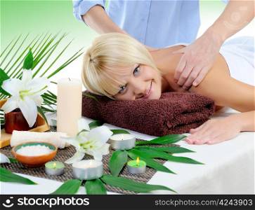 Young beautiful woman in a spa salon massage procedure