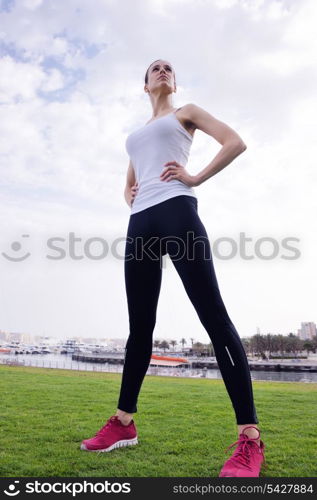 Young beautiful woman jogging and running on morning at park in the city. Woman in sport outdoors health and fitness concept