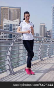 Young beautiful woman jogging and running on morning at park in the city. Woman in sport outdoors health and fitness concept