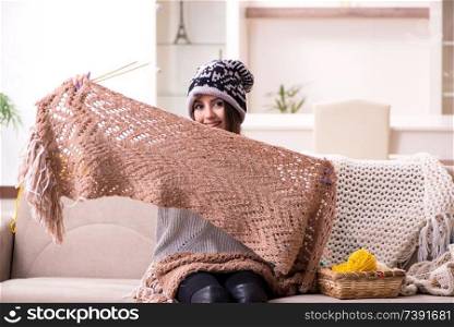 Young beautiful woman knitting at home