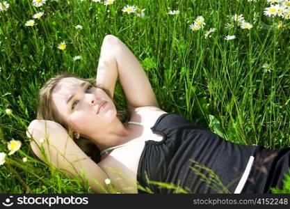 Young Beautiful Woman Laying On The Grass