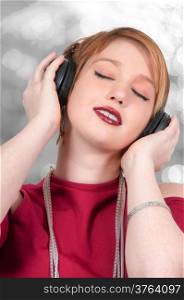 Young Beautiful Woman listening to a set of headphones