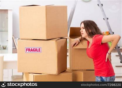 Young beautiful woman moving to new flat 