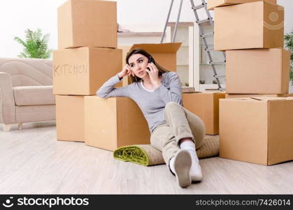 Young beautiful woman moving to new flat 