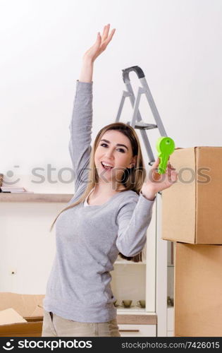 Young beautiful woman moving to new flat 