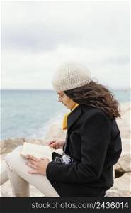 young beautiful woman nature reading book