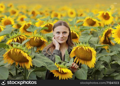 young beautiful woman on blooming sunflower field in summer, health and lifestyle.. young beautiful woman on blooming sunflower field in summer, health and lifestyle