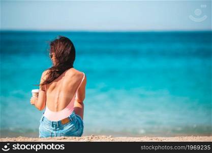 Young beautiful woman on the beach during on tropical vacation. Young beautiful woman on the beach during tropical summer vacation