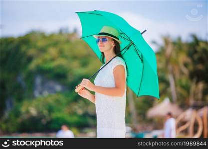 Young beautiful woman on the beach vacation. Young woman in white on the beach