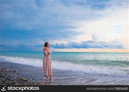 Young beautiful woman on the beach. Woman on the beach enjoying summer holidays