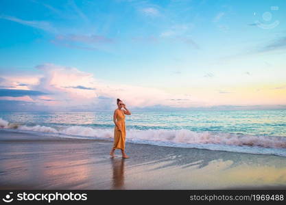 Young beautiful woman on the beach. Woman on the beach enjoying summer holidays