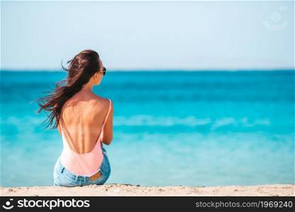 Young beautiful woman on the beach. Young beautiful woman on the beach during tropical summer vacation