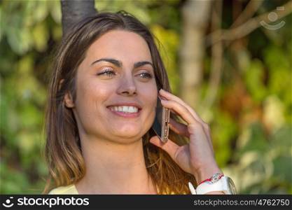 young beautiful woman on the phone, outdoor