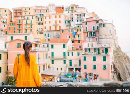 Young beautiful woman on vacation in old italian street. Caucasian tourist walking along the deserted streets of Europe.