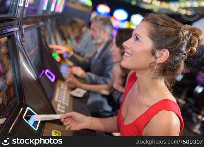 young beautiful woman playing the slot machine